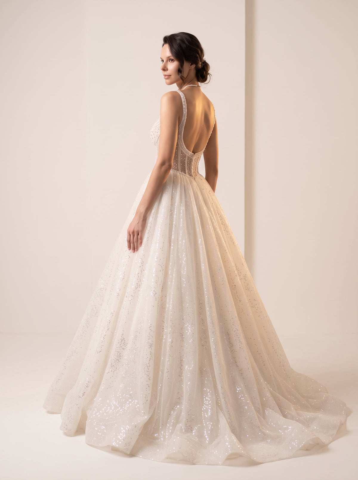 Aurelia Pearl glitter tulle wedding dress back view with pearl buttons and chapel train by Fiore's Bridal - Back View