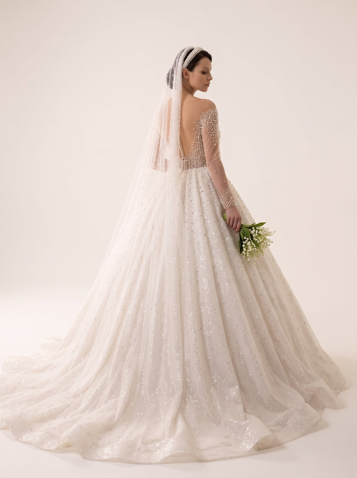 Majesta Pearl ball gown wedding dress back view featuring pearl buttons and cathedral train by Fiore's Bridal - Back View
