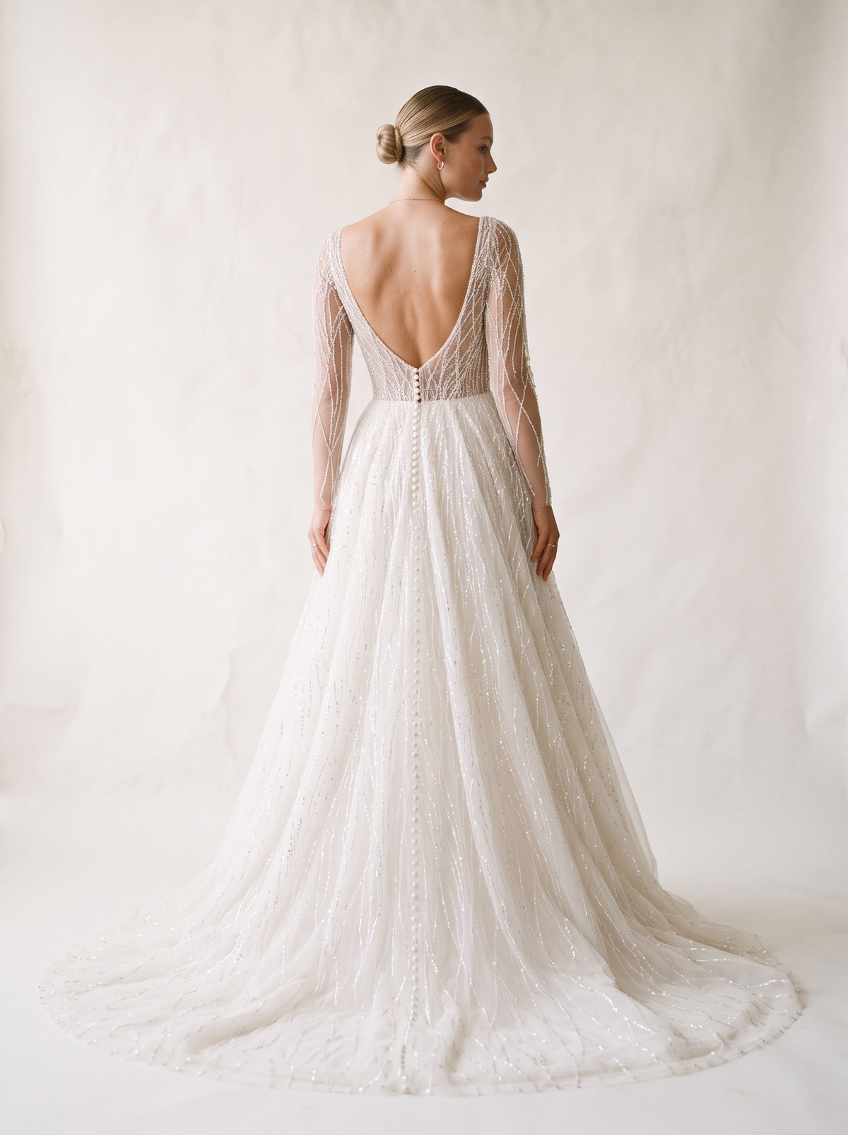 Celeste open back crystal beaded wedding dress with buttons by Fiore's Bridal - Back View