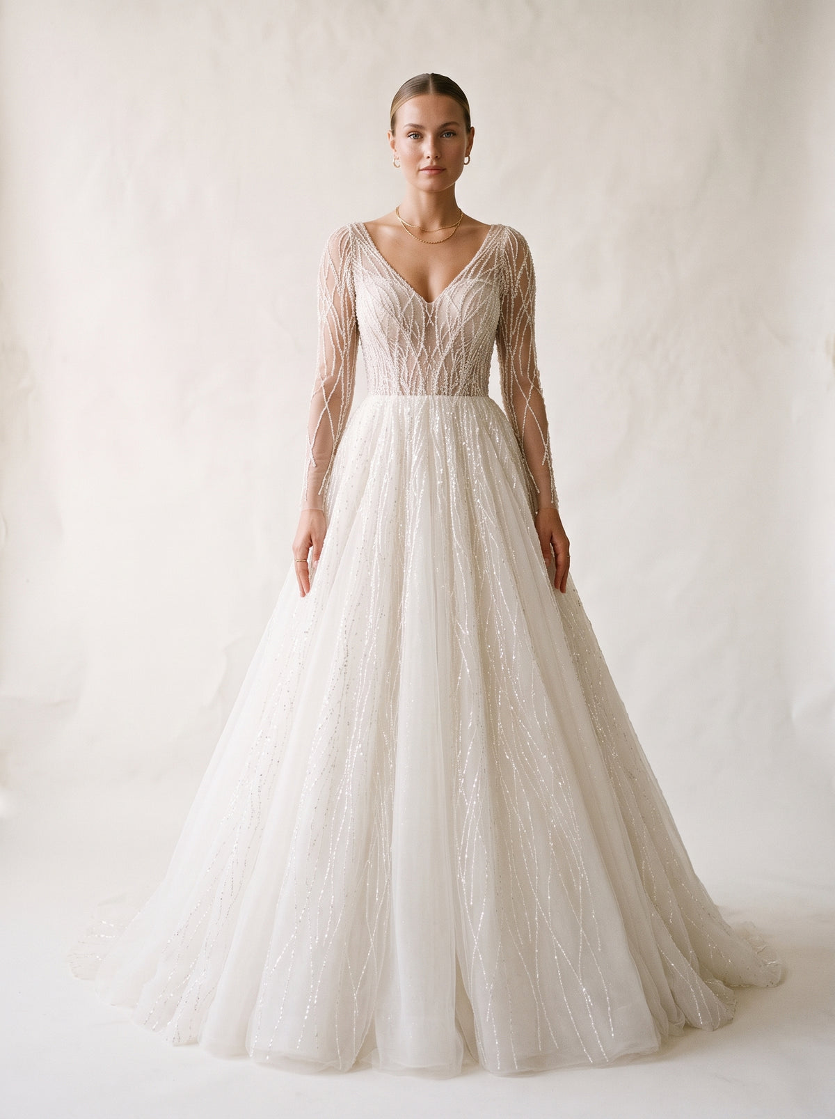 Celeste long sleeve crystal beaded A-line wedding dress by Fiore's Bridal - Front View