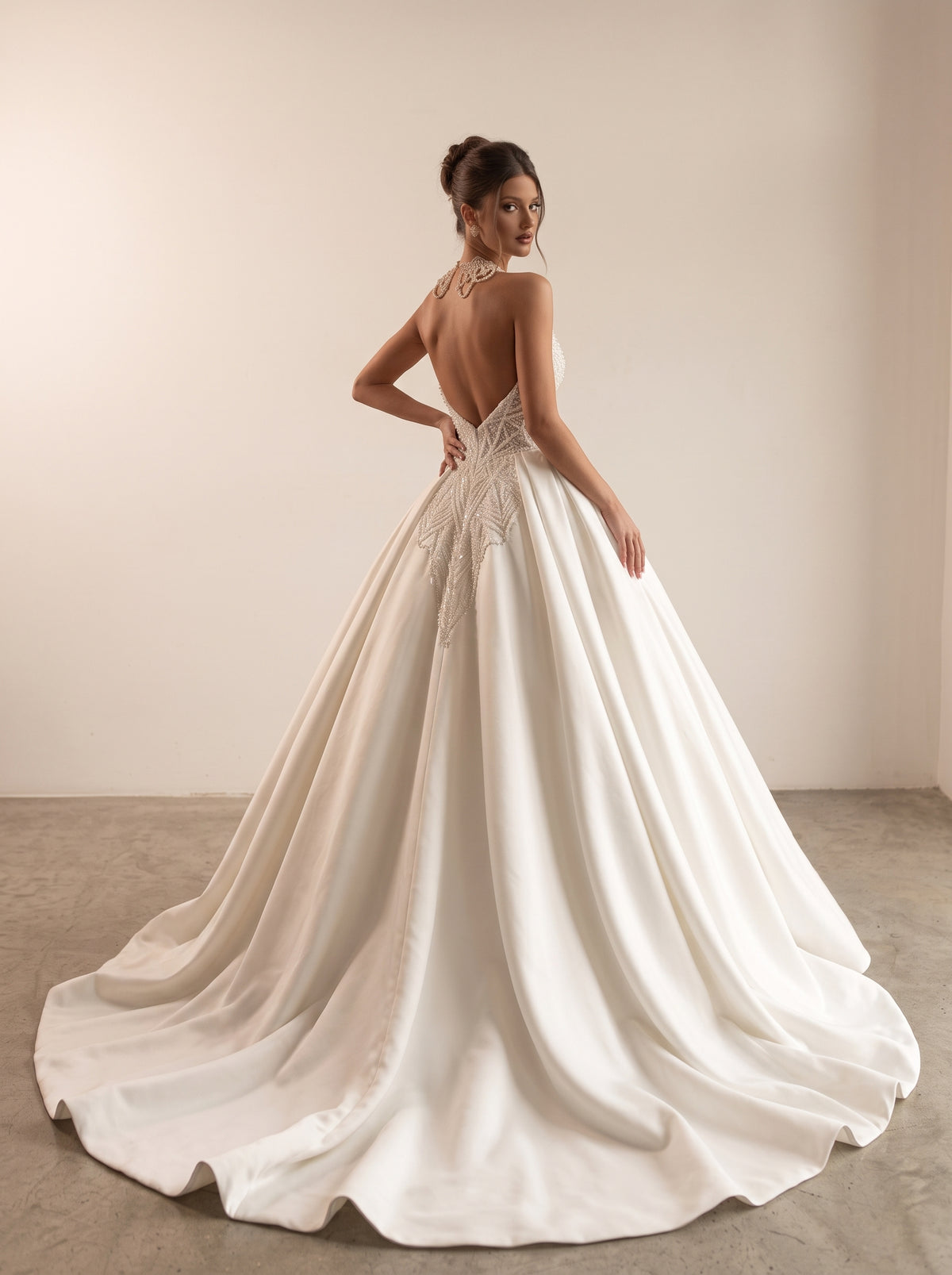 Celine satin ball gown wedding dress back view featuring a clean zipper closure and chapel train by Fiore's Bridal - Back View