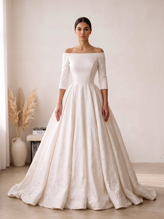 Giselle off-the-shoulder long sleeve satin brocade ball gown wedding dress by Fiore's Bridal - Front View